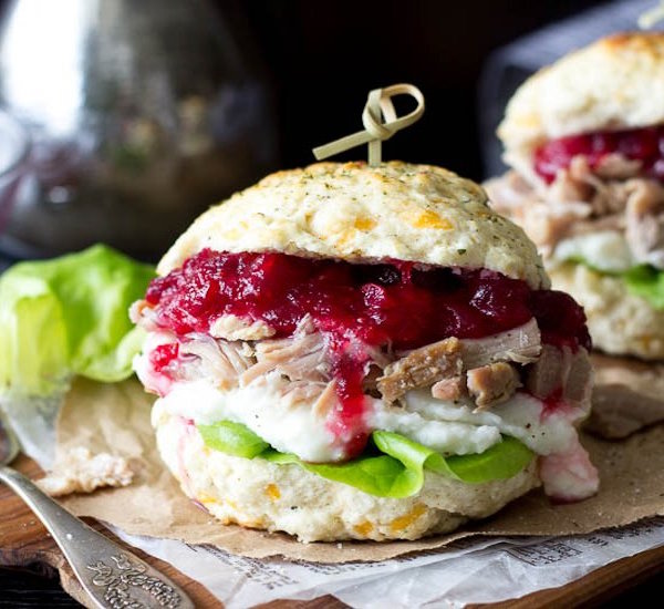 stuffing biscuit, turkey, mashed potato, and cranberry sandwich